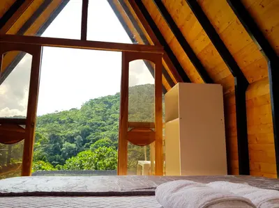 a room with a large window and a refrigerator at Ix Cacao in San Carlos
