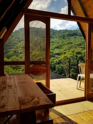 a room with a table and a view of a mountain at Ix Cacao in San Carlos