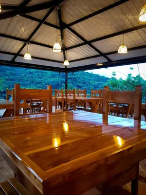 a large wooden table in a room with benches at Ix Cacao in San Carlos