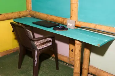 a desk with a laptop and a computer mouse on it at Eco posada El Encuentro San Carlos frente al rio in San Carlos