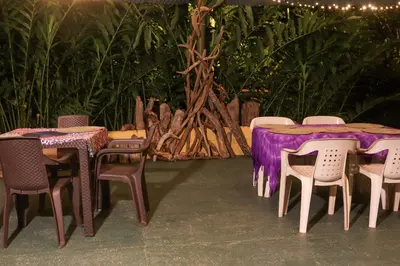 a group of tables and chairs with purple table cloth at Eco posada El Encuentro San Carlos frente al rio in San Carlos