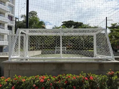 a white gate on a bridge with flowers at Hermoso Apartamento in Santa Fe de Antioquia