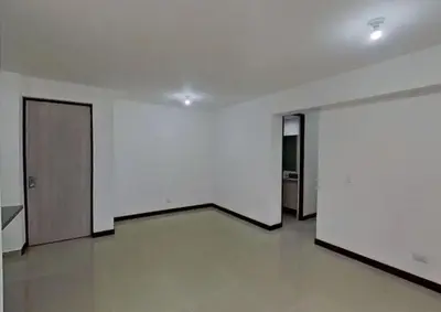 a hallway with white walls and doors in a building at Hospedaje, Nórdica,Medellin,Turosmocolombia-fit in Bello