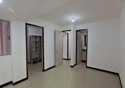a hallway with four doors in a white room at Hospedaje, Nórdica,Medellin,Turosmocolombia-fit in Bello