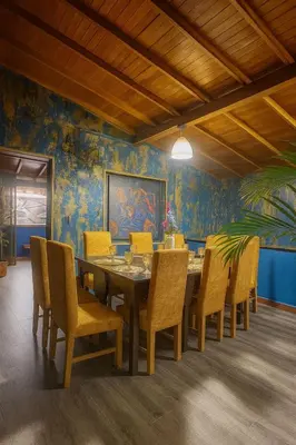 a dining room with a table and chairs at Casa amplia con estilo, poblado, disco y AC in Medellín