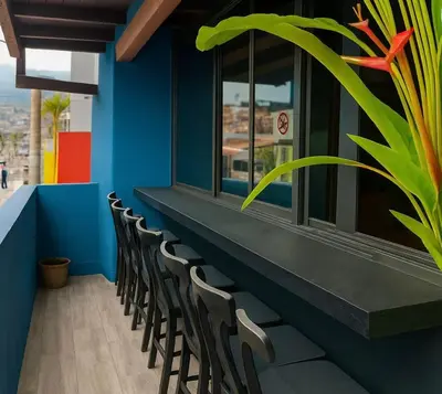 a row of chairs in a restaurant with a blue wall at Casa amplia con estilo, poblado, disco y AC in Medellín