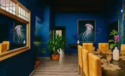 a dining room with blue walls and a table and chairs at Casa amplia con estilo, poblado, disco y AC in Medellín
