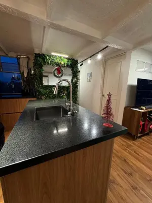 a kitchen with a sink and a counter top at Industrial Chic Apartment Overlooking the City in Medellín