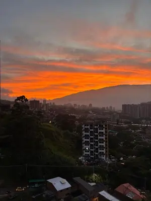 a view of a city with a sunset at Industrial Chic Apartment Overlooking the City in Medellín