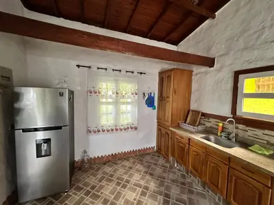 a kitchen with a stainless steel refrigerator and a sink at Melongos Jardín in Jardin