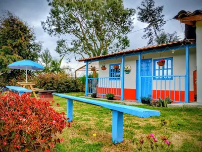 a blue bench in front of a house at Lactesano es Vida in La Unión