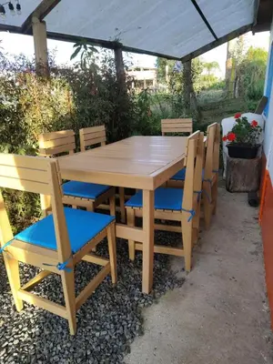 a wooden table and chairs under a canopy at Lactesano es Vida in La Unión