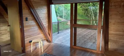 an open door to a porch with a stool at Chalet MA in Guatapé