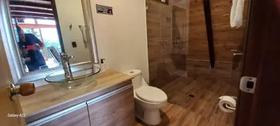 a bathroom with a sink and a toilet and a shower at Chalet MA in Guatapé