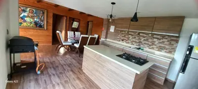 a kitchen with a stove and a counter top at Chalet MA in Guatapé