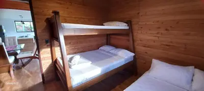 a bedroom with two bunk beds and a desk at Chalet MA in Guatapé