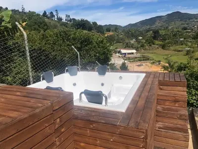 a jacuzzi tub on the deck of a house at Chalet MA in Guatapé
