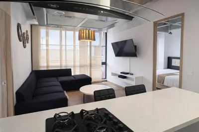 a kitchen and living room with a couch and a table at Envigado Luxury Stay - Apartment in City Plaza in Envigado