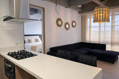 a kitchen and living room with a couch and a bed at Envigado Luxury Stay - Apartment in City Plaza in Envigado