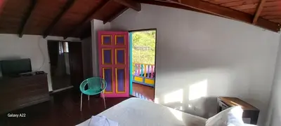 a room with a colorful door and a chair at Casa de Campo MA in Chiquinquirá