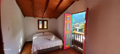 a bedroom with a bed with a colorful door at Casa de Campo MA in Chiquinquirá