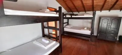 a room with three bunk beds in a room at Casa de Campo MA in Chiquinquirá