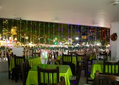 a restaurant with christmas lights on the wall at Hotel Restaurante La Costica Dulce in San Carlos