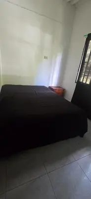 a black bed in a room with a window at Hacienda Popalito in San Rafael