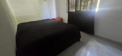 a black bed in a room with a window at Hacienda Popalito in San Rafael