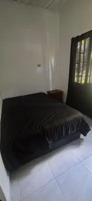 a black bed in a room with a window at Hacienda Popalito in San Rafael