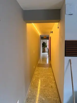 a hallway with yellow walls and a long hallway at Hotel y Restaurante More in Supía