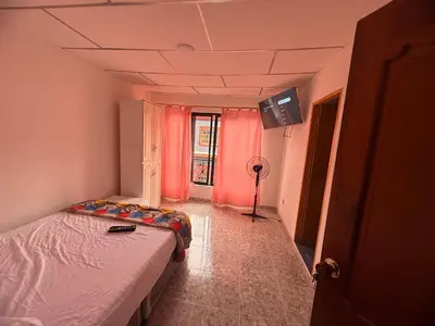a bedroom with a bed and a tv on the ceiling at Hotel y Restaurante More in Supía