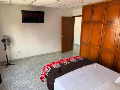 a bedroom with a bed in a room with a fan at Hotel y Restaurante More in Supía