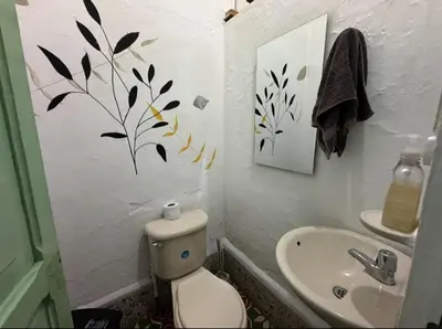 a bathroom with a toilet and a sink at Hostal Prana in Abejorral