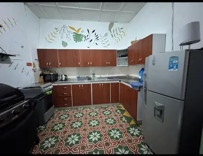 a kitchen with a floor in the middle of a refrigerator at Hostal Prana in Abejorral