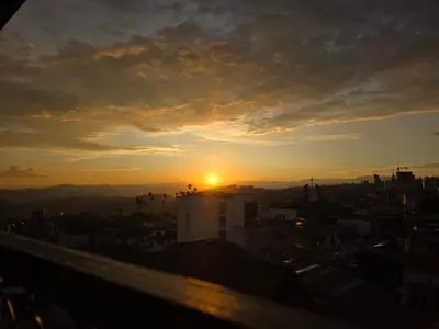 a view of the sunset from the roof of a building at Apartaestudio con vista a AV Santander Manizales in Manizales