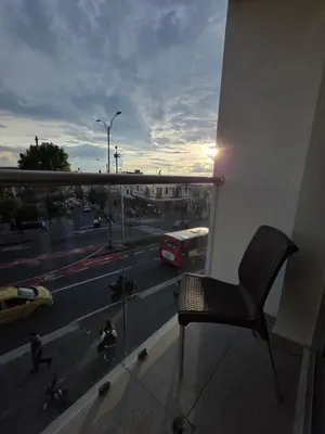 a chair sitting on a balcony looking out at a street at Apartaestudio con vista a AV Santander Manizales in Manizales