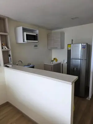 a kitchen with a counter top and a refrigerator at Apartaestudio con vista a AV Santander Manizales in Manizales