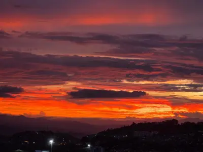 a sunset in the sky with a lot of clouds at Apartaestudio con vista a AV Santander Manizales in Manizales
