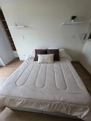 a large white bed in a white room at Apartaestudio con vista a AV Santander Manizales in Manizales