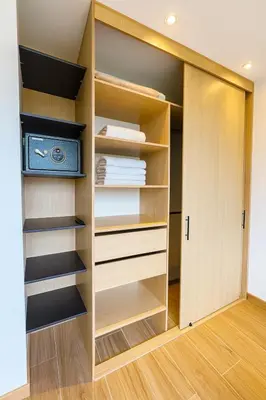 a closet with wooden shelves and a television at El Poblado Two-Level Luxury Penthouse Amazing View in Medellín