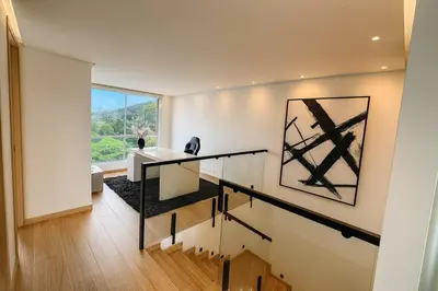 a staircase in a house with a painting on the wall at El Poblado Two-Level Luxury Penthouse Amazing View in Medellín