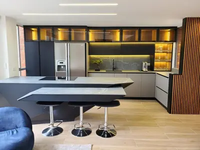 a kitchen with a large island with two bar stools at El Poblado Two-Level Luxury Penthouse Amazing View in Medellín