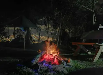 a fire in the grass next to a picnic table at Cabaña Privada Pachamama Ancestral in Medellín