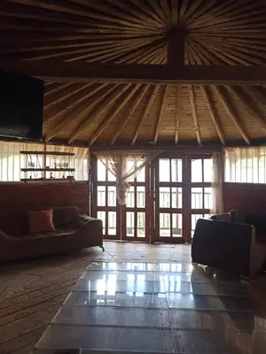 a living room with couches and a large wooden ceiling at Cabaña Privada Pachamama Ancestral in Medellín