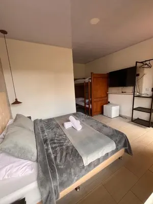 a bedroom with a bed with a towel on it at Entre Aguas Hotel in Guatapé