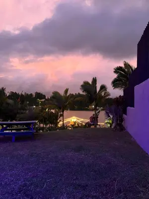 a park with a view of the water and palm trees at Entre Aguas Hotel in Guatapé