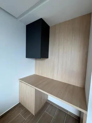 a kitchen with a shelf and a black cabinet at El Poblado Amazing Penthouse with Breathtaking Views in Medellín