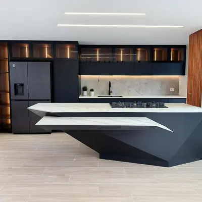 a kitchen with black cabinets and a white counter top at El Poblado Amazing Penthouse with Breathtaking Views in Medellín