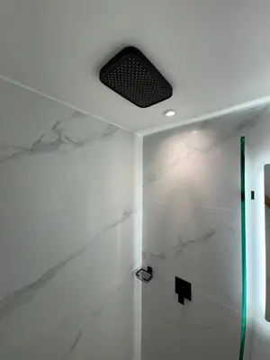 a bathroom with a shower and a ceiling fan at El Poblado Amazing Penthouse with Breathtaking Views in Medellín